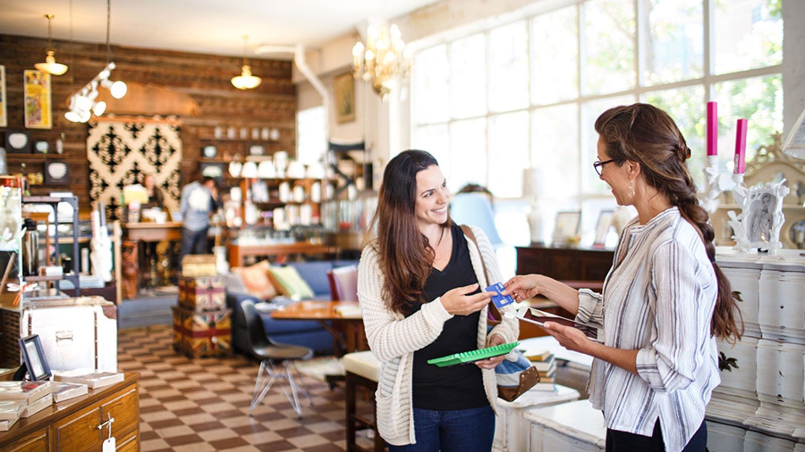 Woman paying with Visa chip card at a store