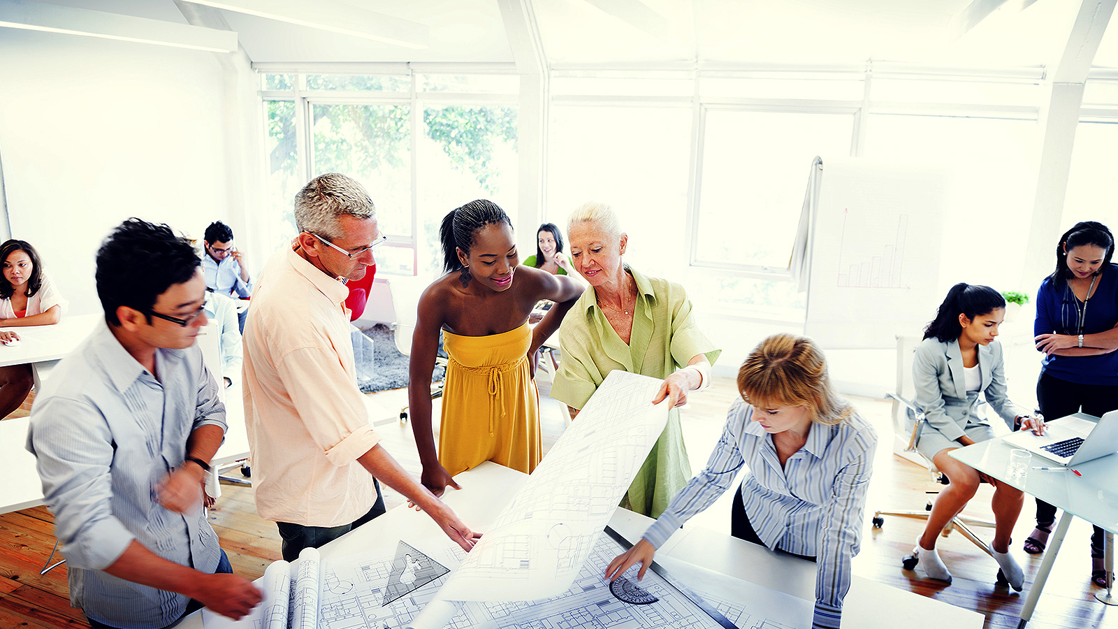 diverse group of people standing around a table