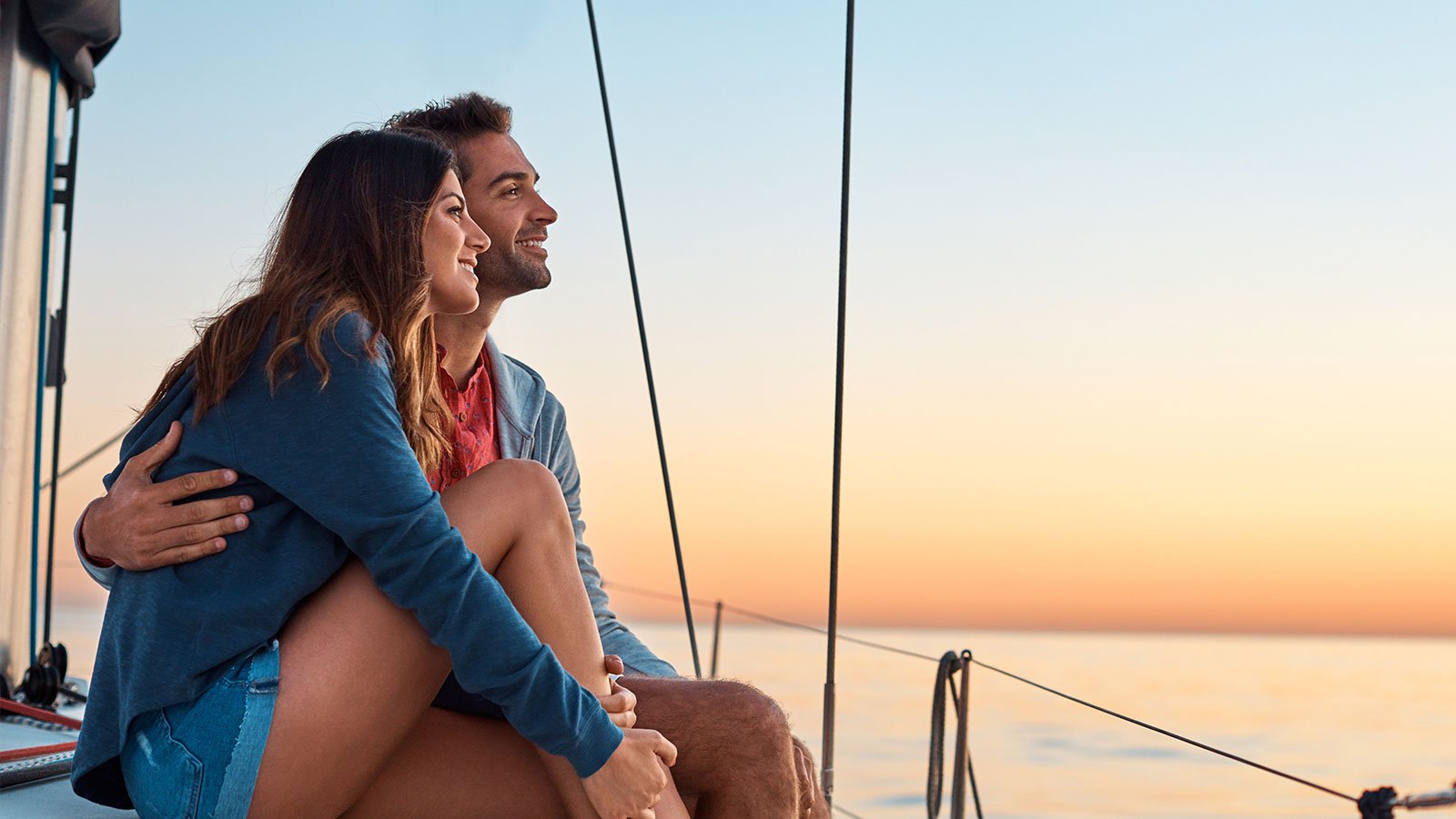 Woman and man embraced watching sunset